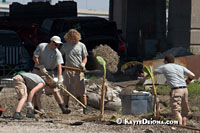 Americorp volunteers, Elizabeth Topham (Philadelphia), Joseph Fogarty (Long Island, NY), Peter Mills, (Shoreview, MN) and Eric Crawford (Philadelphia) work in the Bioremediation Garden at Common Ground Relief's Midtown Operation Center at Art Egg in New Orleans. In addition to the Bioremediation Gardens, Common Ground educates residents and provides them plants to help reduce toxins in the soil.